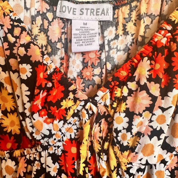 Mid length dress with a red, oranges, yellow and black. Cap sleeves. - Picture 2 of 4